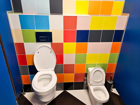 Shared family bright restroom with two toilet bowl in mall. Unisex WC for woman, man, mom dad, boy girl, kid. Use together. Recreation room, toilet for adult, little child. Big parents, children cabin.の写真素材