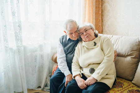 Elderly senior romantic love couple. Old retired man woman together. Aged husband wife in cozy home sweater.Elder hugging kissing people pensioner.Happy family longevity.Tender feelings relationships.の写真素材