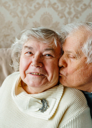 Elderly senior romantic love couple. Old retired man woman together. Aged husband wife in cozy home sweater.Elder hugging kissing people pensioner.Happy family longevity.Tender feelings relationships.の写真素材