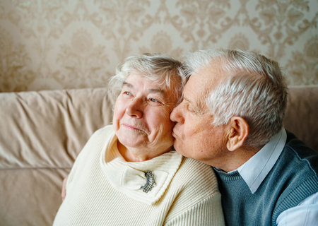 Elderly senior romantic love couple. Old retired man woman together. Aged husband wife in cozy home sweater.Elder hugging kissing people pensioner.Happy family longevity.Tender feelings relationships.の写真素材