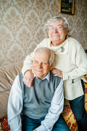 Elderly senior romantic love couple. Old retired man woman together. Aged husband wife in cozy home sweater.Elder hugging kissing people pensioner.Happy family longevity.Tender feelings relationships.の写真素材