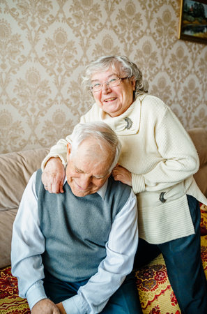 Elderly senior romantic love couple. Old retired man woman together. Aged husband wife in cozy home sweater.Elder hugging kissing people pensioner.Happy family longevity.Tender feelings relationships.の写真素材
