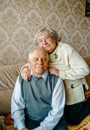 Elderly senior romantic love couple. Old retired man woman together. Aged husband wife in cozy home sweater.Elder hugging kissing people pensioner.Happy family longevity.Tender feelings relationships.の写真素材