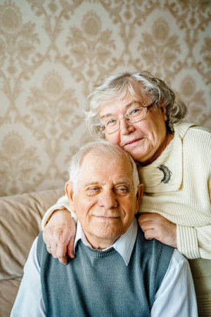 Elderly senior romantic love couple. Old retired man woman together. Aged husband wife in cozy home sweater.Elder hugging kissing people pensioner.Happy family longevity.Tender feelings relationships.の写真素材