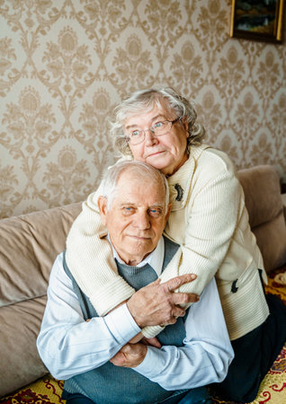 Elderly senior romantic love couple. Old retired man woman together. Aged husband wife in cozy home sweater.Elder hugging kissing people pensioner.Happy family longevity.Tender feelings relationships.の写真素材