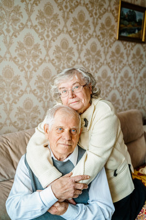 Elderly senior romantic love couple. Old retired man woman together. Aged husband wife in cozy home sweater.Elder hugging kissing people pensioner.Happy family longevity.Tender feelings relationships.の写真素材