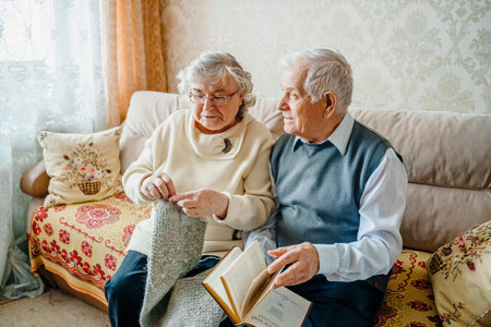 Elderly senior romantic love couple. Old retired man woman together. Aged husband wife in cozy home sweater.Elder hugging kissing people pensioner.Happy family longevity.Tender feelings relationships.の写真素材