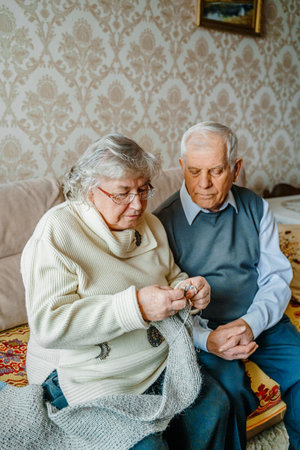 Elderly senior romantic love couple. Old retired man woman together. Aged husband wife in cozy home sweater.Elder hugging kissing people pensioner.Happy family longevity.Tender feelings relationships.の写真素材