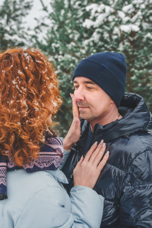 Love romantic love story. Happy couple of middle aged millennials, bright red-haired woman in winter...