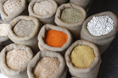 Beans, rice, lentils, oats, wheat, rye and barley in jute sackの写真素材
