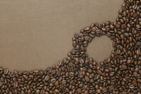 Caffe edition, coffee beans on old brown paperの写真素材