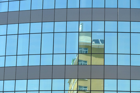 Reflection in windows of modern office building
