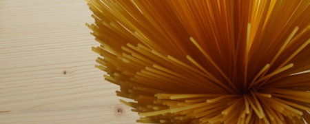 Bundle of raw uncooked Italian pasta spaghetti macaroni background - banner  header editionの写真素材
