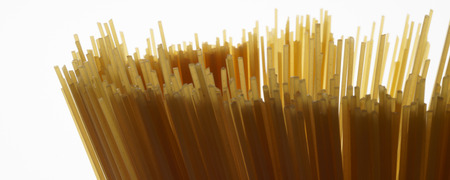 Bundle of raw uncooked Italian pasta spaghetti macaroni background - banner  header edition