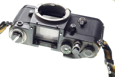 Part of the old dirty abandoned and forgotten  photographic camera on white background - place for...