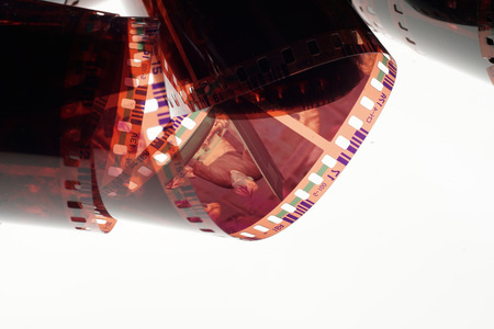 Old negative 35 mm film strip on white background, strip of tangled camera film - place for copy and space textの写真素材