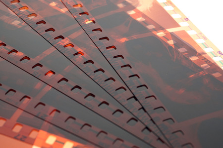Old negative 35 mm film strip on white background, strip of tangled camera film - place for copy and space textの写真素材