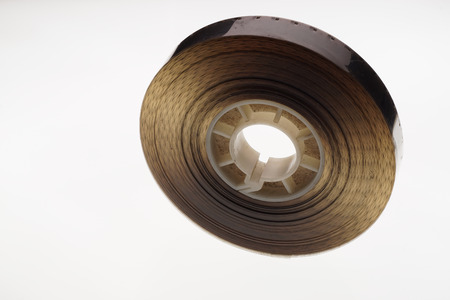 Old positive 16 mm film strip on white background, strip of tangled movie film - place for copy and space textの写真素材