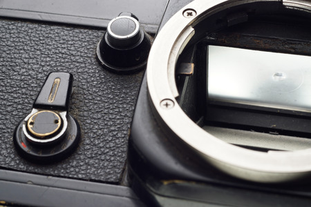 Part of the old dirty abandoned and forgotten  photographic camera on white background - place for...
