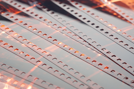 Old negative 35 mm film strip on white background, strip of tangled camera film - place for copy and space textの写真素材