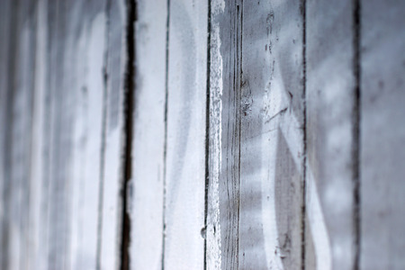 Old fence made of boards faded over time due to the rain and sun. Texture background with space for copy and textの写真素材