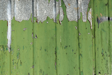 Cracked and peeling green paint on a metal surface-Abstract monochrome backgroundの写真素材