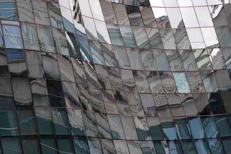 Reflection in windows of modern building in which is reflected the surrounding architecture
