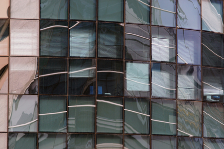 Reflection in windows of modern building in which is reflected the surrounding architecture