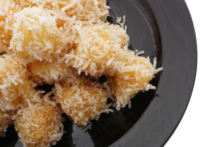 Chinese food. Caramelized apples in black plate isolated on white. Closeup.の写真素材