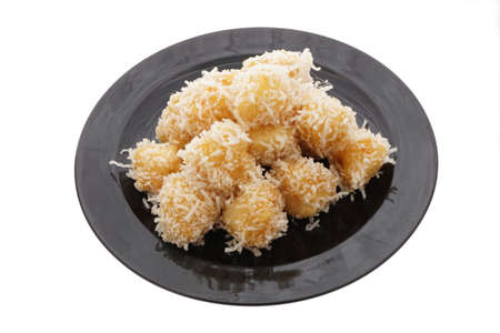 Chinese food. Caramelized apples in black plate isolated on white. Closeup.の写真素材