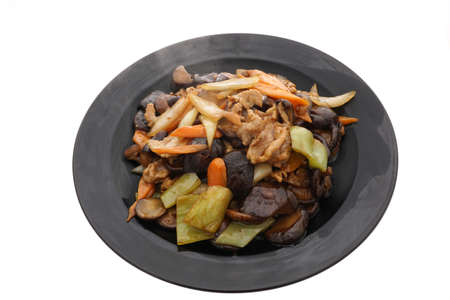 Chinese food. Fried mushrooms with vegetables in black plate isolated on white. Closeup.の写真素材