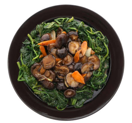Chinese food. Fried mushrooms with vegetables in black plate isolated on white. Closeup.の写真素材