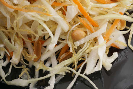 Chinese food. Gold and silver salad with vegetables in black plate. Closeup.の写真素材