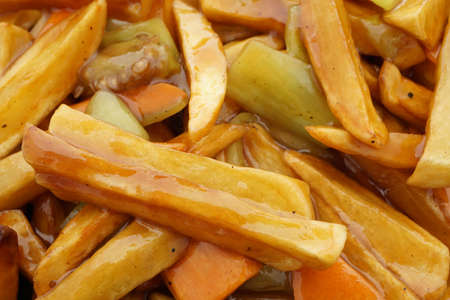 Chinese food. Fried potato chips in sauce. Closeup.