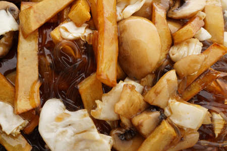 Chinese food. Fried potato chips with mushrooms. Closeup.