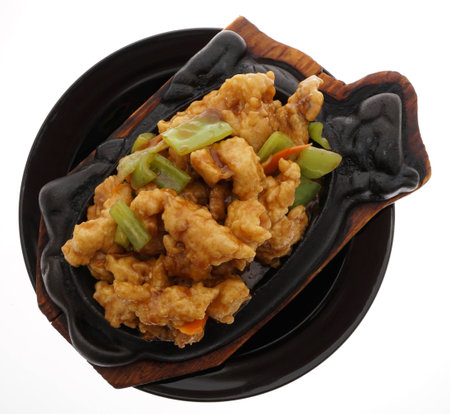 Chinese food. Fish terrine with vegetables in black plate isolated on white. Closeup.の写真素材