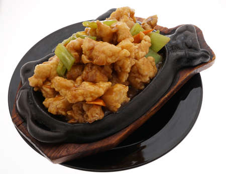 Chinese food. Fish terrine with vegetables in black plate isolated on white. Closeup.の写真素材