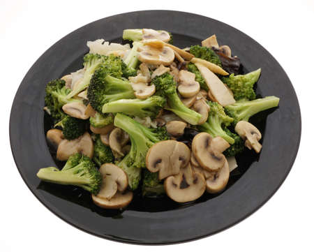 Chinese dish. Chinese food. Broccoli with chinese mushrooms in black plate isolated on white. Closeup.の写真素材