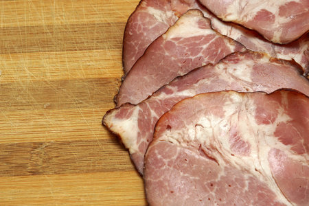 Sliced pork ham on wooden background. close-upの写真素材