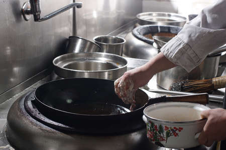 Close up of working chef preparing chinese food, Food frying in wok pan. Sale and food concept の写真素材