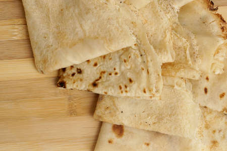 Freshly baked rolled blinis or crepes on wooden board, close upの写真素材