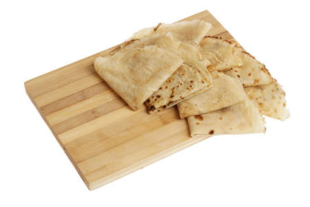 Fresh hot blinis or crepes with chocolate spread isolated on white