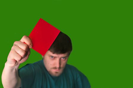 An image of a man showing a red card                                の写真素材