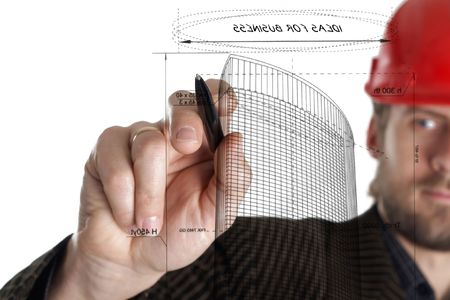 An image of constructor in a rad helmet drawing with a penの写真素材