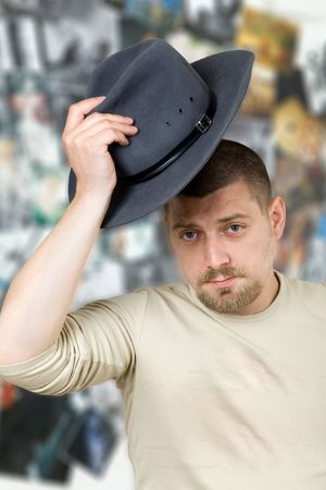 Bearded man with grey hat in hand