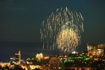 An image of fireworks over nightlife cityの写真素材