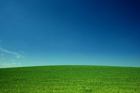 An image of sky over green fieldの写真素材