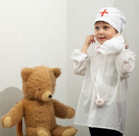 Little girl with toy-phonendoscope playing a doctorの写真素材