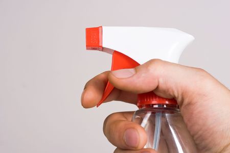 Bottle with liquid for cleining in hand