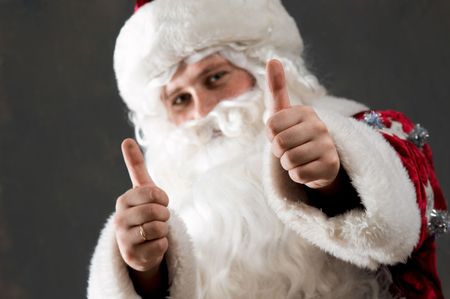 Santa Claus is preparing to celebrate Christmas. Showing tumbの写真素材